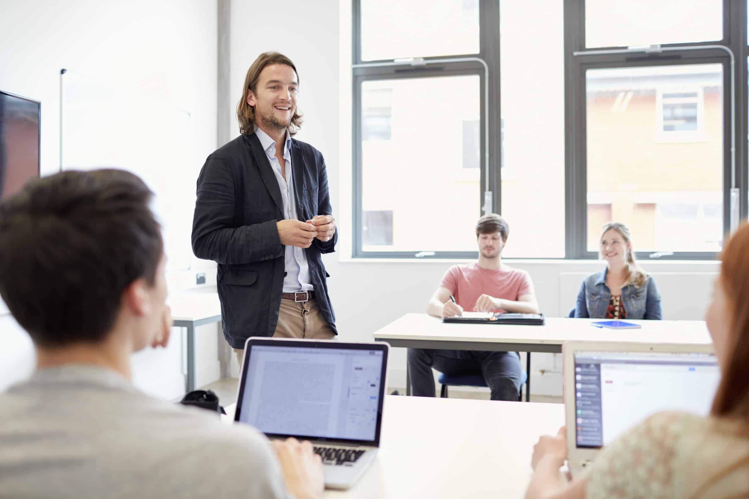 male-lecturer-teaching-students-using-laptops-in-h-2021-11-16-17-00-16-utc male-lecturer-teaching-students-using-laptops-in-h-2021-11-16-17-00-16-utc