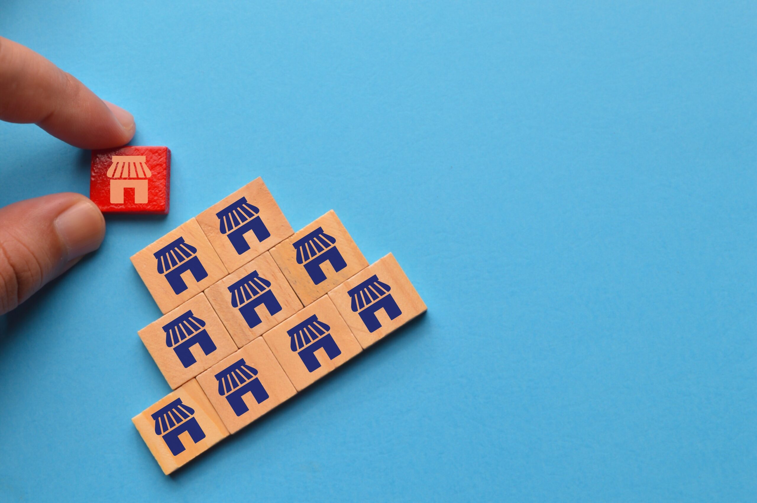 man-hand-picked-wooden-block-with-store-icons-bus-2022-11-02-16-33-49-utc man-hand-picked-wooden-block-with-store-icons-bus-2022-11-02-16-33-49-utc