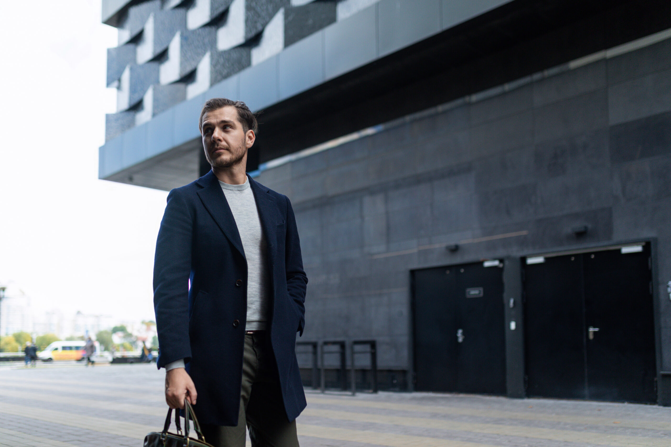 stylish businessman walking around the city with a briefcase