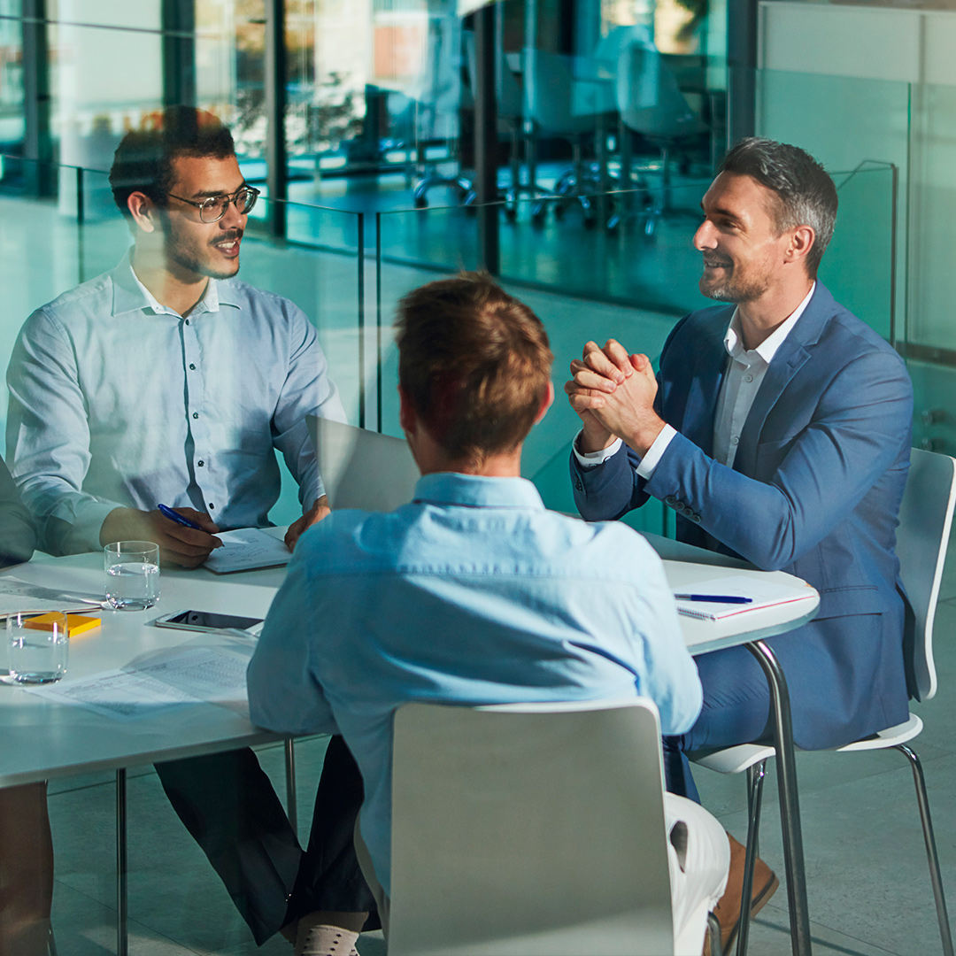 Three Men Sitting on the table and discussing about Truepeoplesearch Removal