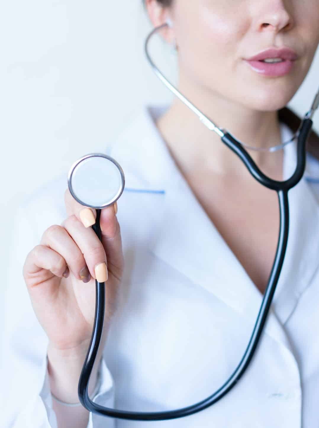 A woman holding stethoscope