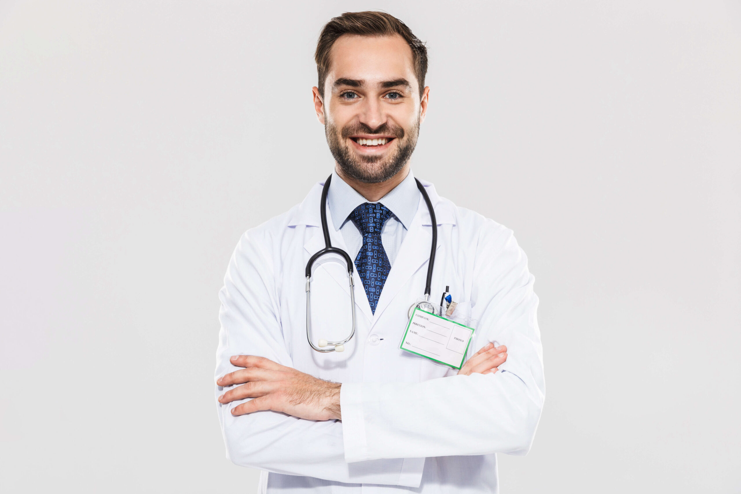 A doctor smiling in the camera with stethoscope around his neck