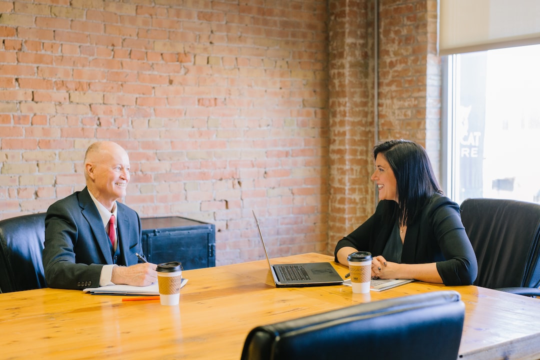 Two people sitting on the table and discussing about Beenverified Remove